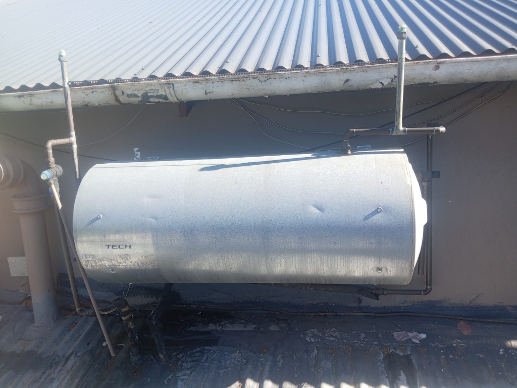 Domestic hot water geyser installation under roof eave