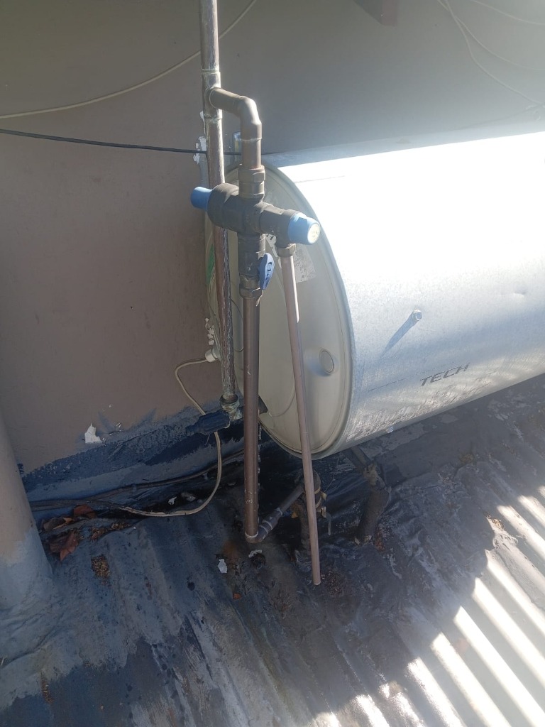 Close-up of geyser safety pressure control valve and copper plumbing